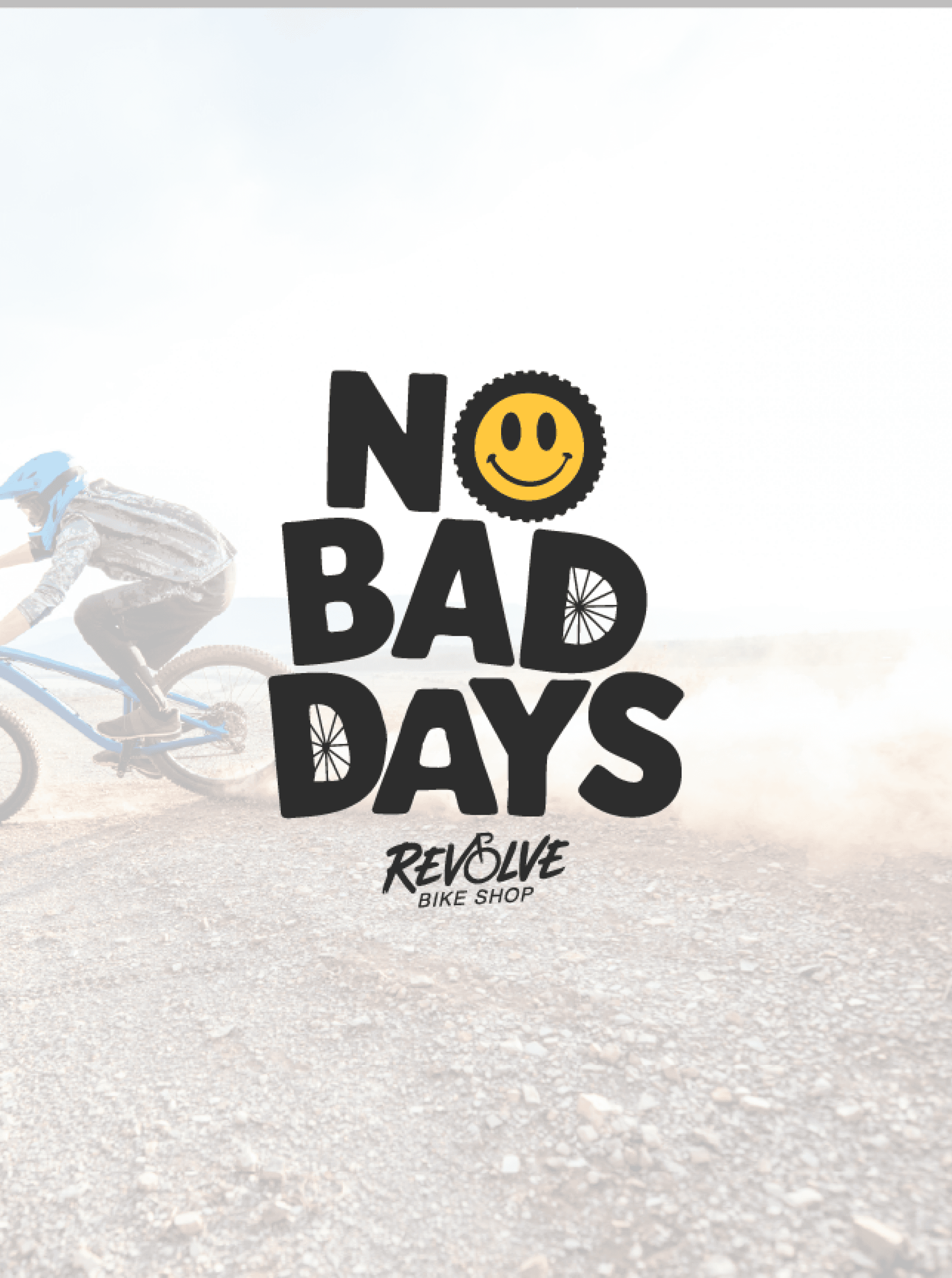 No Bad Days poster with a yellow smiley in the O, set over a dusty mountain biker and the Revolve logo