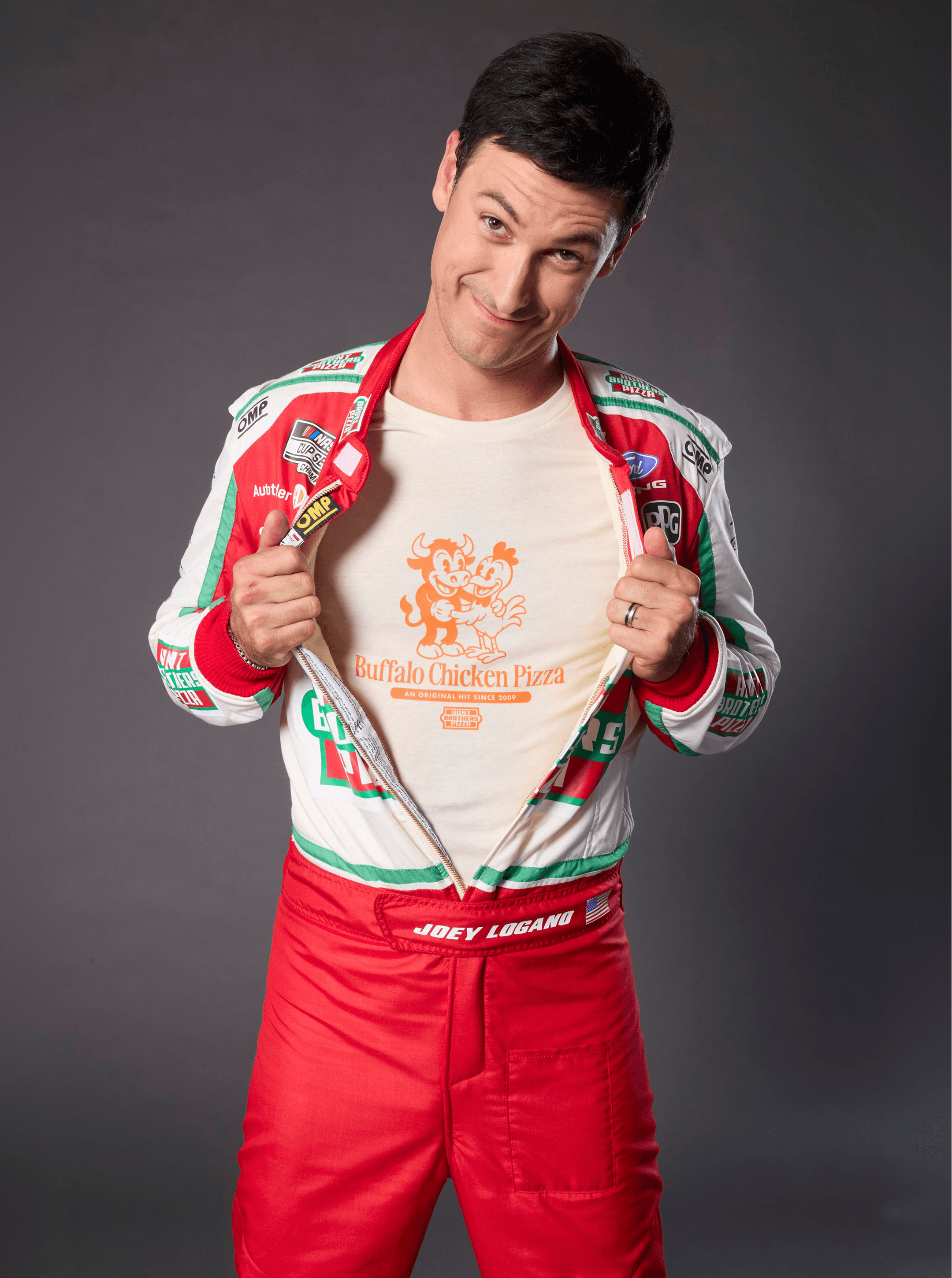 Driver pulling open his race suit to show a Buffalo Chicken Pizza cartoon T-shirt underneath