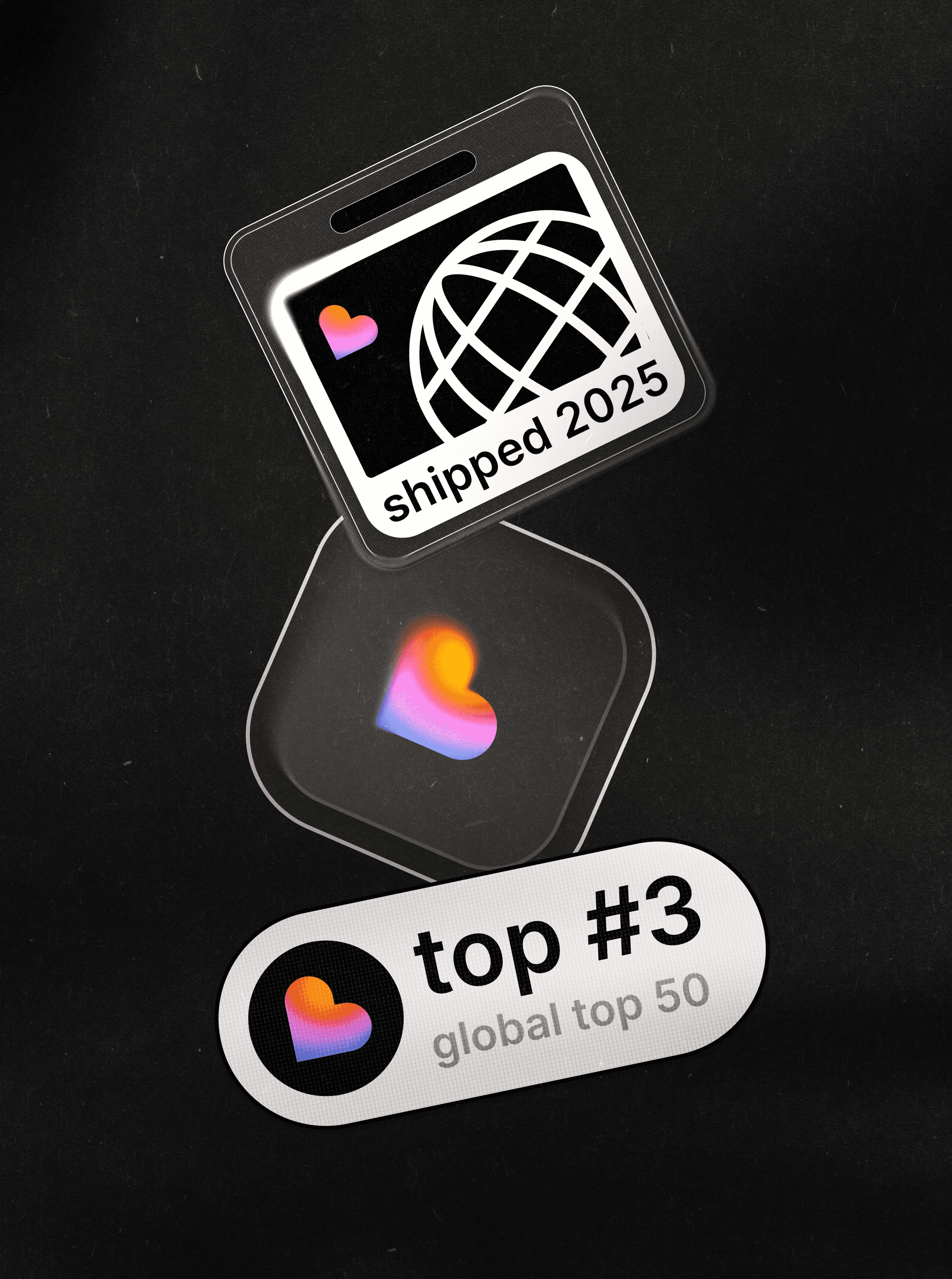 Three Lovable keepsakes on black felt: a globe badge marked "shipped 2025", a clear heart tag and a "top #3" pill
