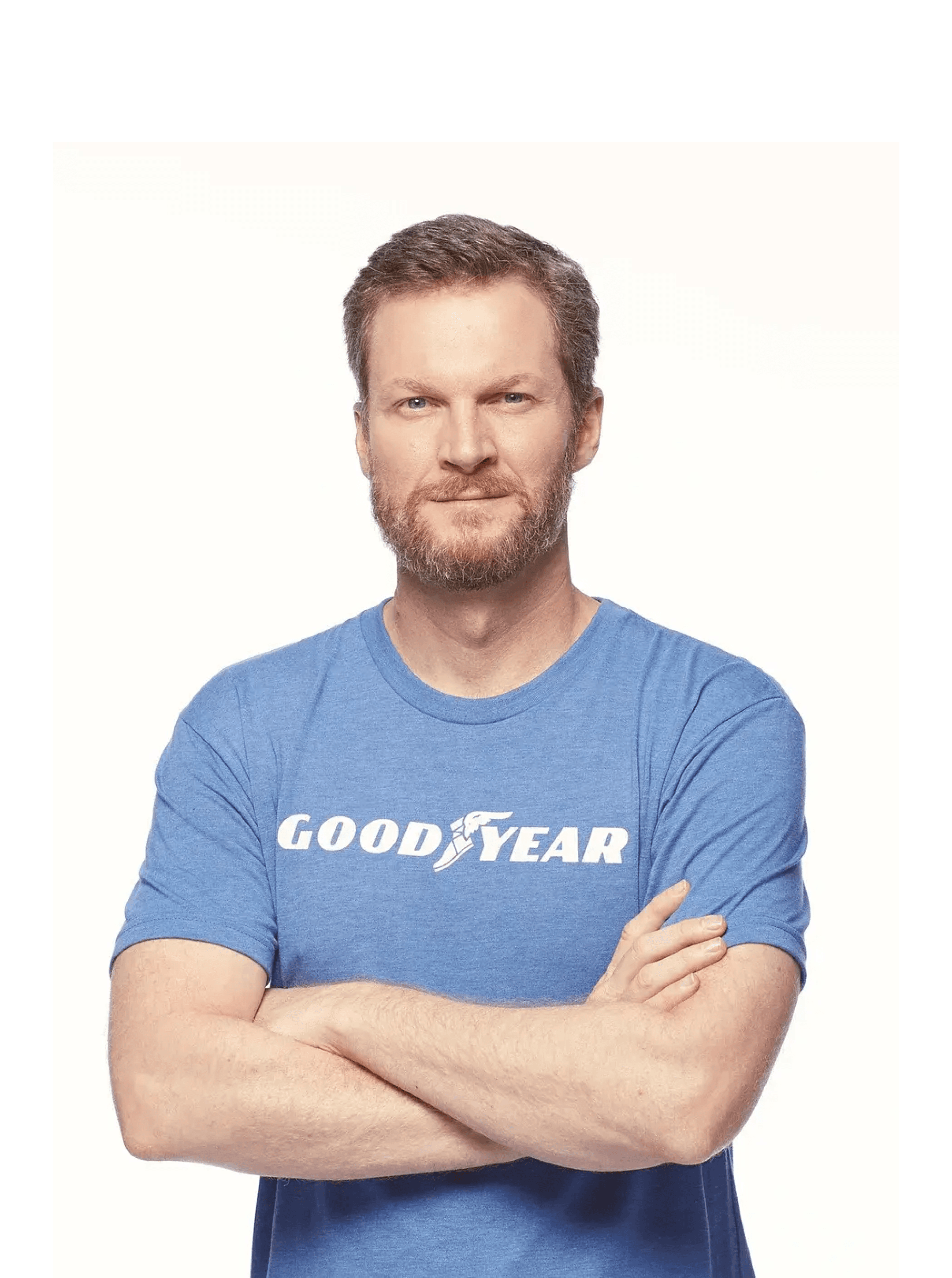 Bearded man in a blue Goodyear T-shirt photographed against a plain white background, arms folded
