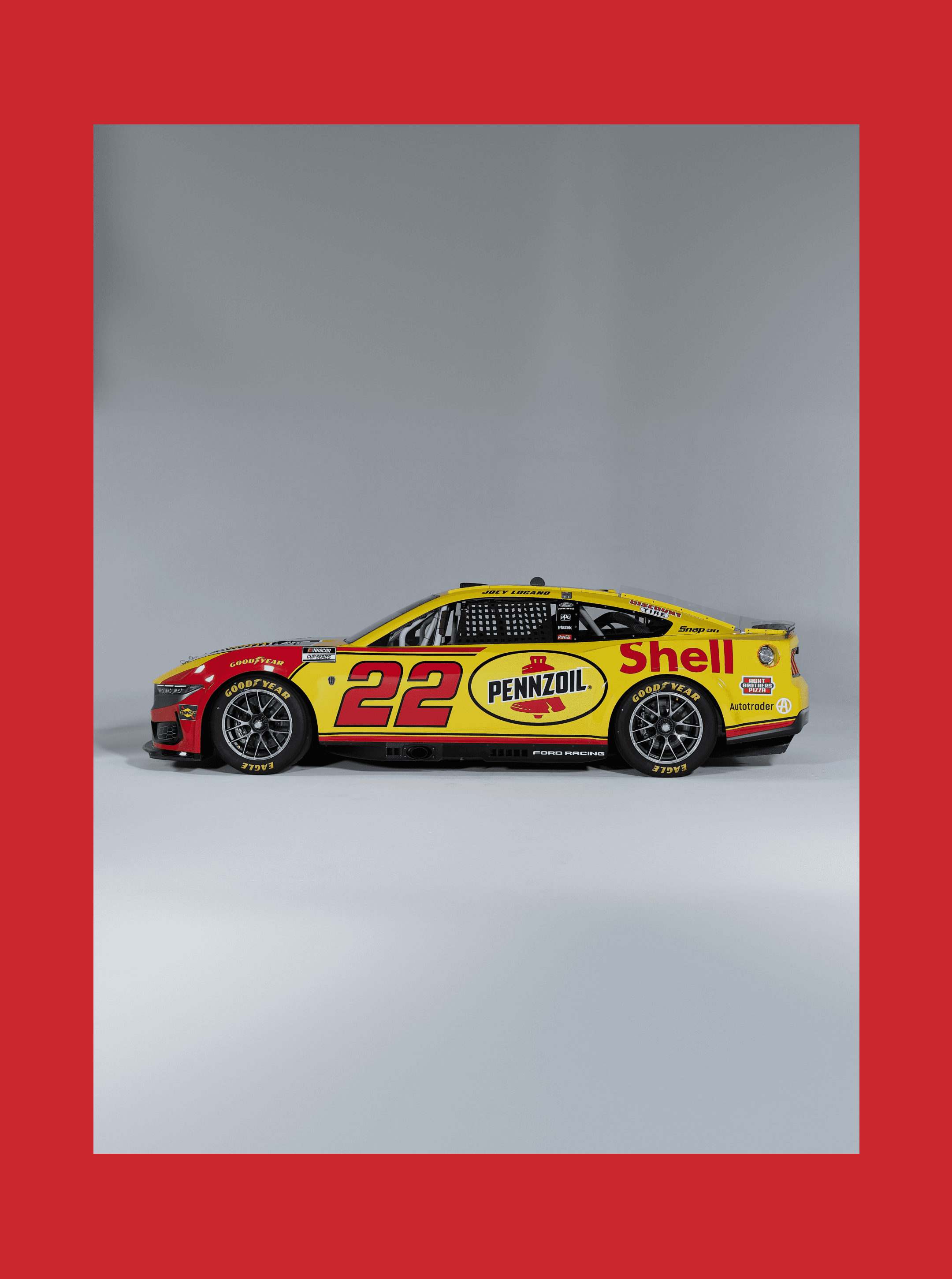 Profile view of the No. 22 Shell Pennzoil stock car centered in a white frame on a red field