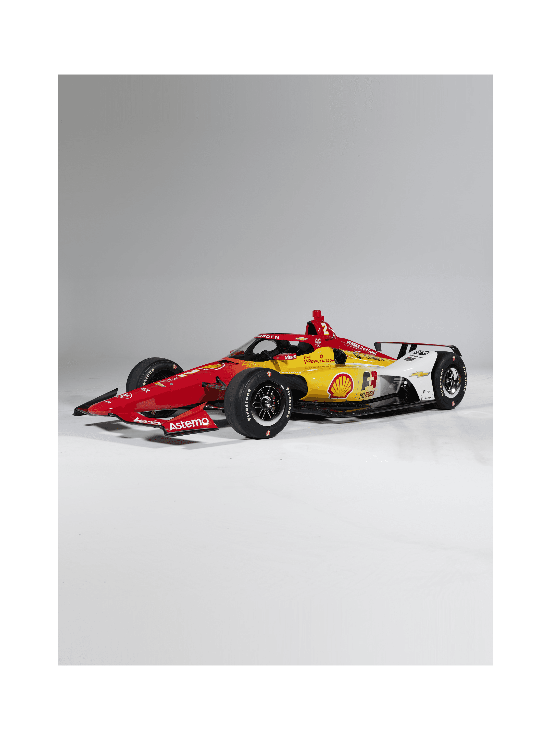 Red, yellow and white Shell Pennzoil IndyCar shot alone at a three-quarter front angle on white